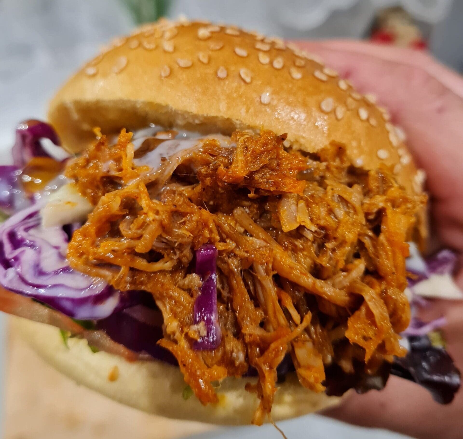 smoked pulled pork roll with cabbage and sauces